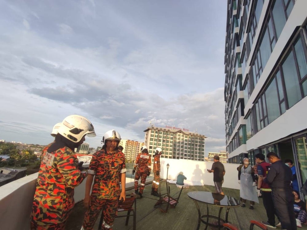 The fire brigade carried out an operation to bring down the body of the victim who fell from the 14th floor of a hotel building in Kota Kinabalu - FILE PIC 