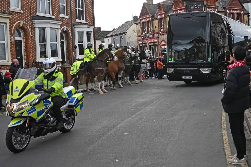 The Manchester United team coach receives a police escort ahead of the English Premier League derby between Liverpool and Manchester United at Anfield in Liverpool tonight. Reports confirm two official bids for a takeover of Manchester United from the American Glazer family. - AFP