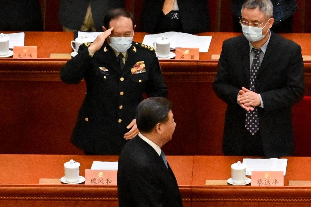 China's Defence Minister Wei Fenghe (top L) salutes as China's President Xi Jinping (bottom) arrives for the opening ceremony of the Chinese People's Political Consultative Conference (CPPCC) at the Great Hall of the People in Beijing on March 4, 2023. (Photo by NOEL CELIS / AFP)