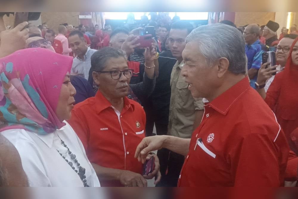Ahmad Zahid (right) when he arrived at Tan Sri Mohamed Rahmat Complex on Sunday.