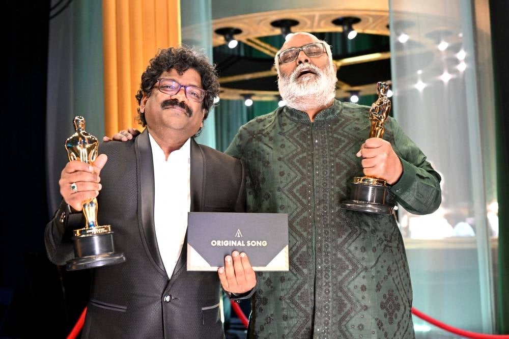 In this handout photo provided by A.M.P.A.S., Best Original Song winners for 'Naatu Naatu' from "RRR," Chandrabose and M. M. Keeravani are seen backstage during the 95th Annual Academy Awards on March 12, 2023 in Hollywood, California. - AFP
