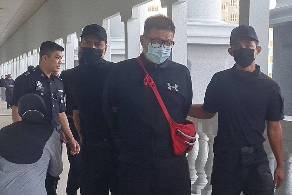The police brought Kian Voon (second from right) to face three criminal charges at the Kuala Lumpur Magistrate's Court on Friday - FILEPIC