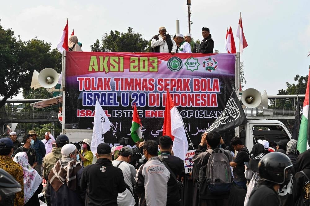 Indonesians take part in a rally in Jakarta on March 20, to demand their government to reject the participation of Israel's team in the upcoming 2023 FIFA U-20 World Cup, which is to be hosted by Indonesia between May 20 and June 11. - AFP