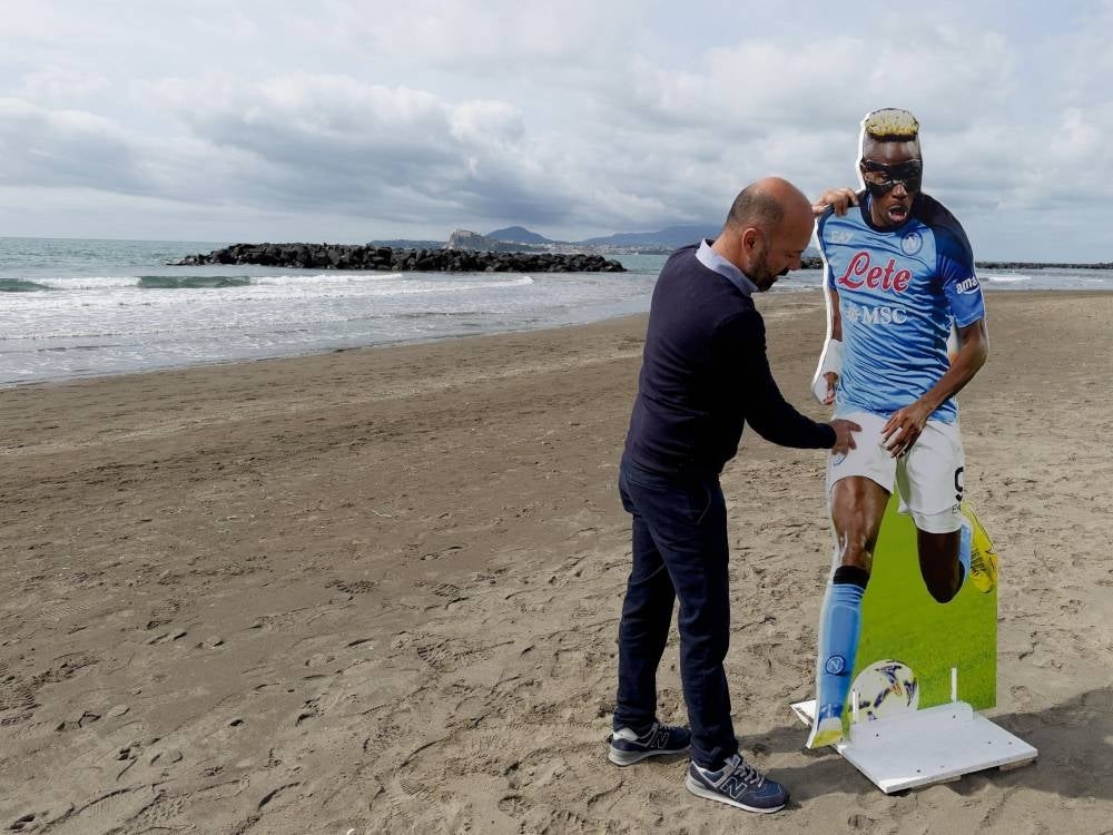 A cardboard cutout of SSC Napoli player Victor Osimhen is set up on the beach in Bacoli, Naples, Italy, on March 30. SSC Napoli will play against AC Milan in an Italian Serie A soccer match on April 2 in what is touted as the title decider. 2023. Nigerian striker Osimhen, however, has been ruled out of the match with a groin injury. - Pic: EPA