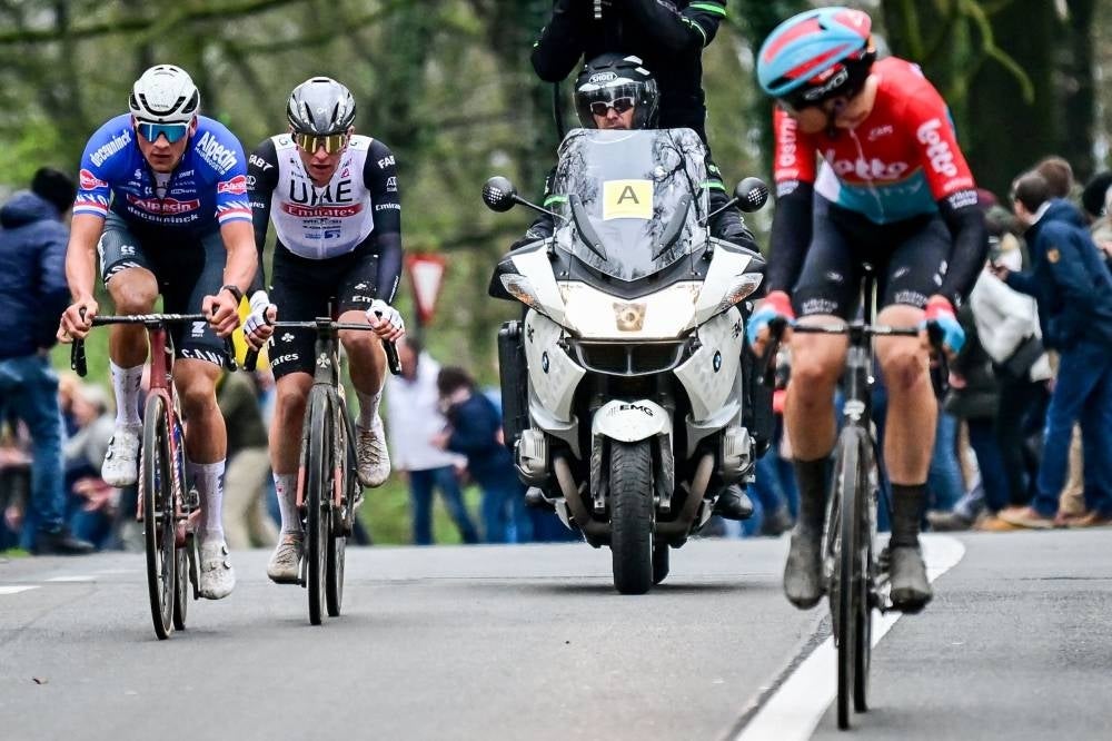 Netherlands' Mathieu van der Poel (L) of Alpecin-Deceuninck, Slovenia's Tadej Pogacar (C) of UAE Team Emirates and Belgium's Florian Vermeersch (R) of Lotto-Dstny ride during the men's Tour of Flanders one day cycling event, 273,4km from Bruges to Oudenaarde, on April 2. - Pic: AFP