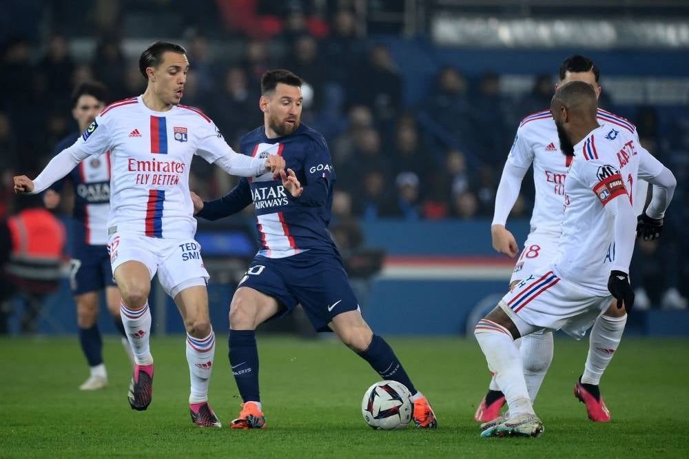 Paris Saint-Germain's Argentine forward Lionel Messi (2ndL) and Lyon's French midfielder Maxence Caqueret fight for the ball during the French L1 football match between Paris Saint-Germain (PSG) and Olympique Lyonnais (OL) at The Parc des Princes Stadium in Paris on April 2. - Pic: AFP