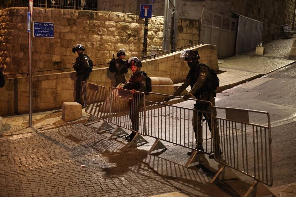 Israeli border guards stand by a barricade outside the Al-Aqsa Mosque compound at Lion's Gate in Jerusalem's Old City during clashes with Palestinians in Al-Aqsa Mosque on April 5, 2023. - AFP 