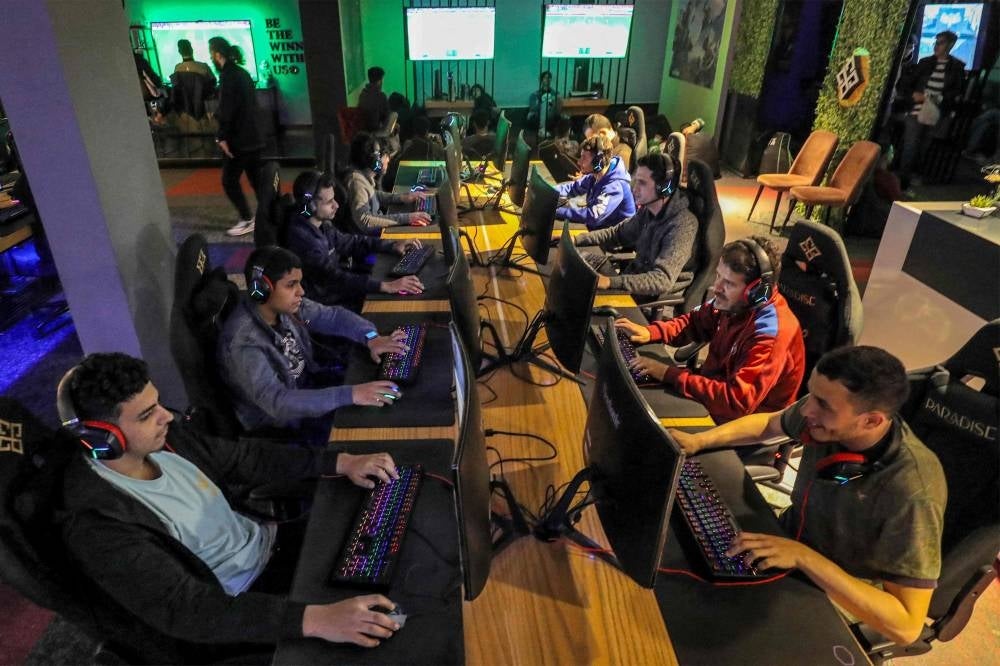 Youths play at a video gaming centre in Libya's capital Tripoli. - In an ultra-modern gaming space in Tripoli, players exchange banter amid the bleeping and music of video games. Isolated by decades of dictatorship and post-revolution chaos, Libyan gamers are finally ready to take on the world. - Pic: AFP