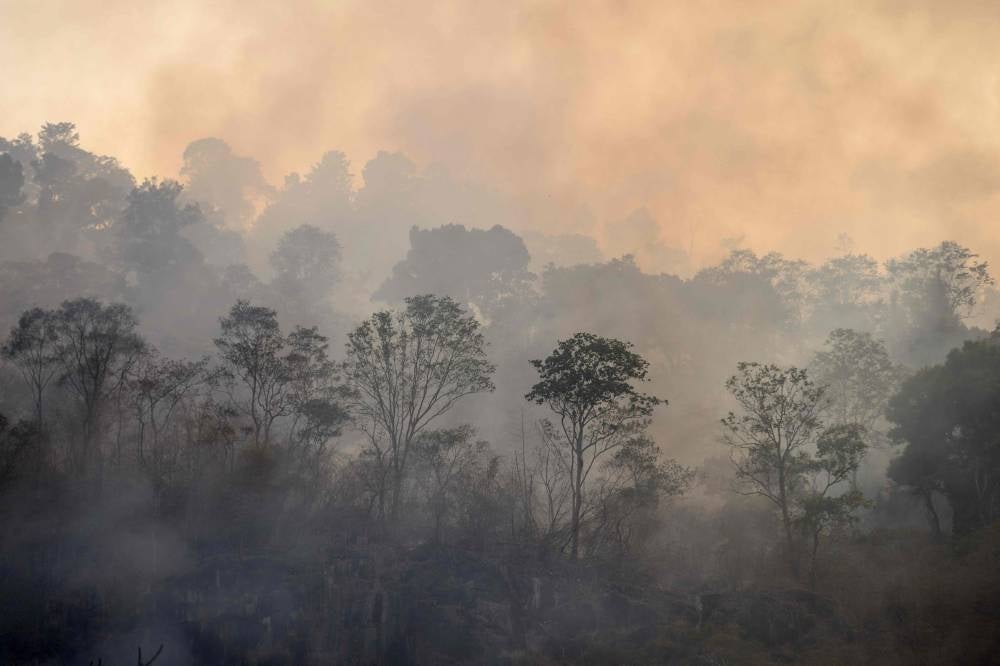 Smoke billows out from a forest fire on a mountain-side in Nakhon Nayok province, northeast of Bangkok on March 31. - Hundreds of Thai firefighters and soldiers battled a forest blaze less than 100 kilometres from Bangkok as the kingdom grapples with air pollution. - Pic: AFP
