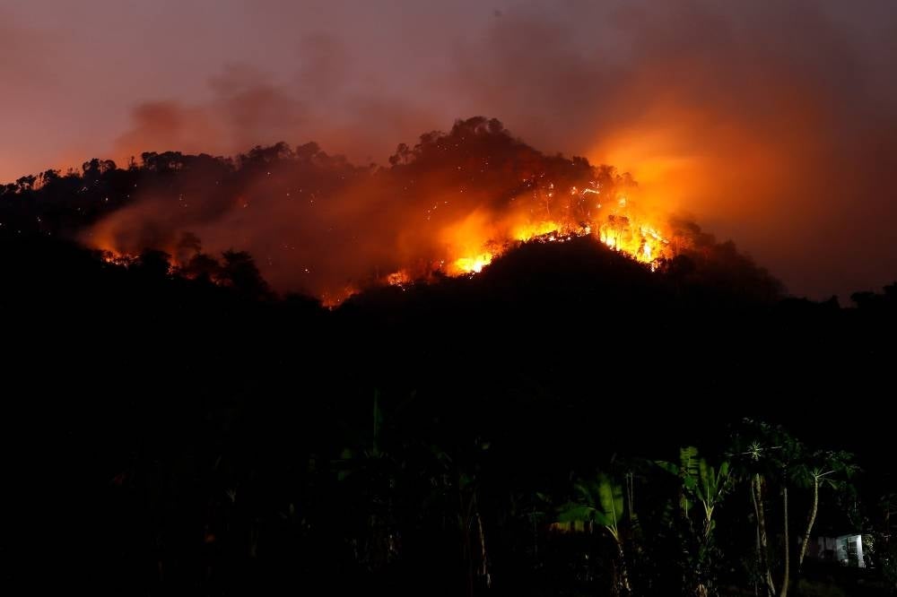 This photograph taken on March 30 shows a forest fire in Nakhon Nayok province, northeast of Bangkok. Authorities in the Northern city of Chiang Mai today urged residents to stay indoors as air pollution reached hazardous levels. - Pic: AFP