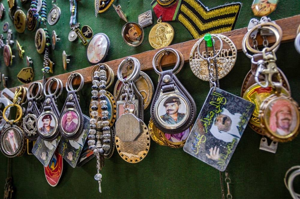 Keychains showing portraits of Iraq's late ousted dictator Saddam Hussein and the country's first modern monarch King Faisal I are displayed at an antique shop in Baghdad. - Twenty years after the fall of his regime, the late Iraqi president Saddam Hussein remains admired and popular in Jordan where his image can still be seen across the country. The instantly recognisable face peers out from car stickers to mobile phone covers in Jordan, despite symbols and images associated with his rule being widely considered taboo in Iraq itself. - Pic: AFP