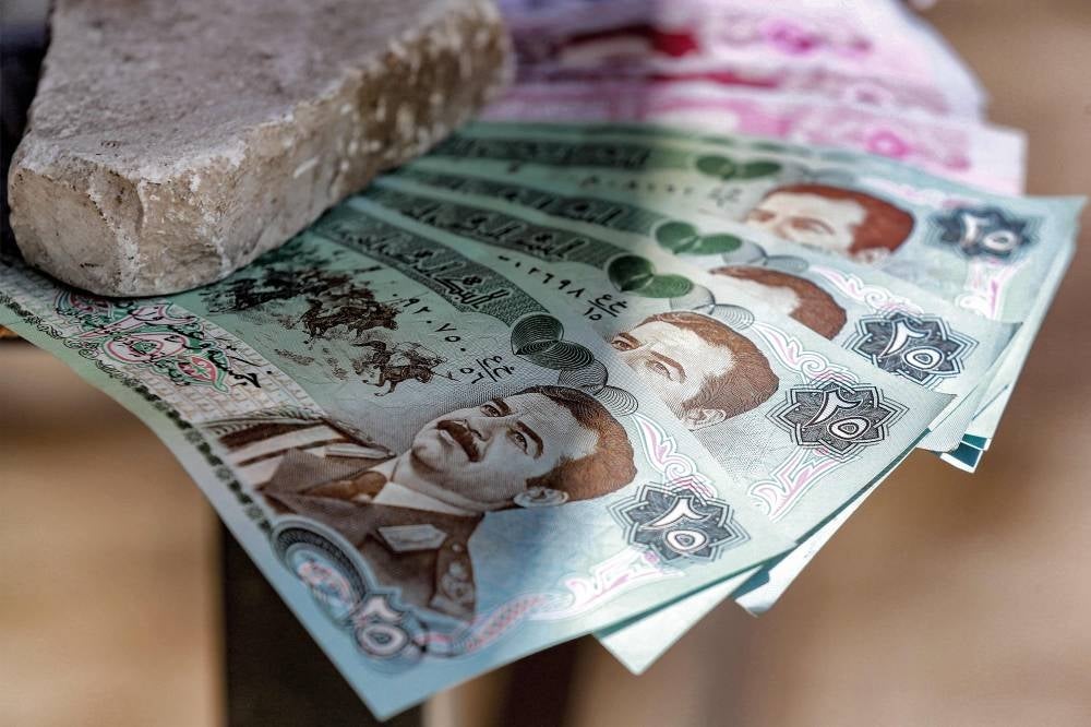 Old Iraqi dinar banknotes showing the image of Iraq's late ousted dictator Saddam Hussein are displayed at a shop in Amman. - Twenty years after the fall of his regime, the late Iraqi president Saddam Hussein remains admired and popular in Jordan where his image can still be seen across the country. The instantly recognisable face peers out from car stickers to mobile phone covers in Jordan, despite symbols and images associated with his rule being widely considered taboo in Iraq itself. - Pic: AFP