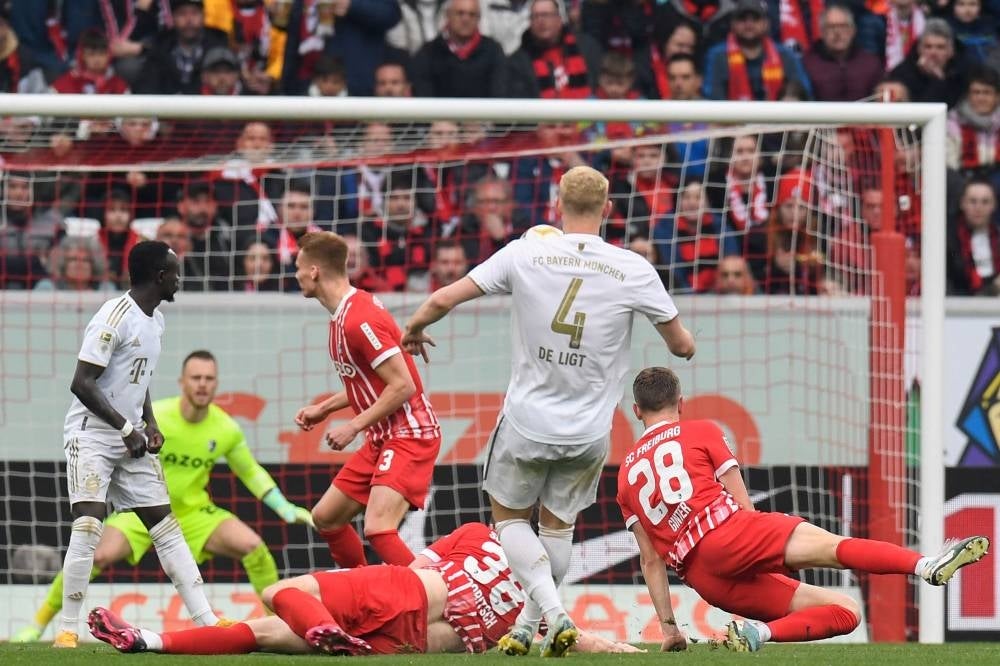 Bayern Munich's Dutch defender Matthijs de Ligt (C) scoring the opening goal during the German first division Bundesliga football match between SC Freiburg and Bayern Munich in Freiburg on April 8. - Pic: AFP