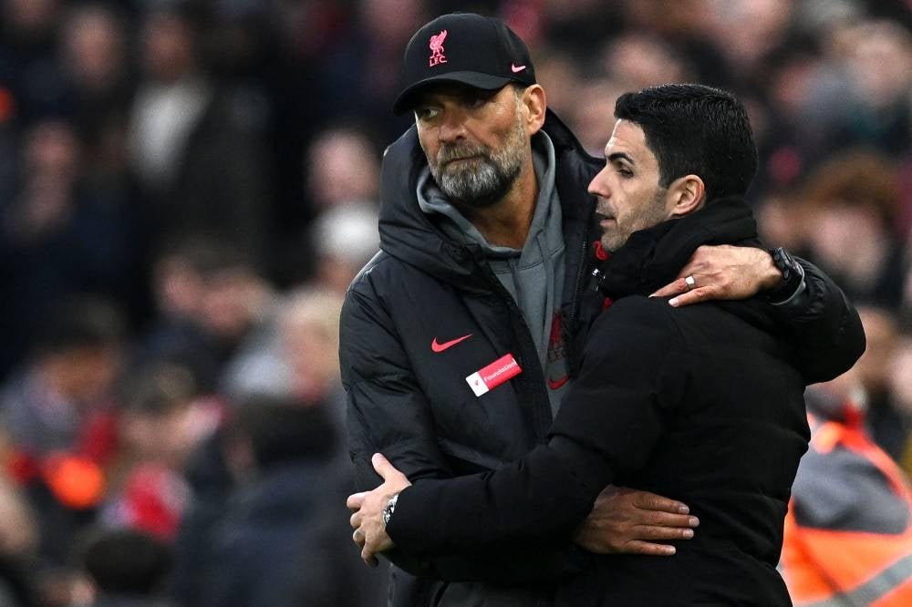 Liverpool's German manager Jurgen Klopp (L) embraces Arsenal's Spanish manager Mikel Arteta after the English Premier League football match between Liverpool and Arsenal at Anfield in Liverpool, north west England on April 9. - The match ended 2-2. - Pic: AFP