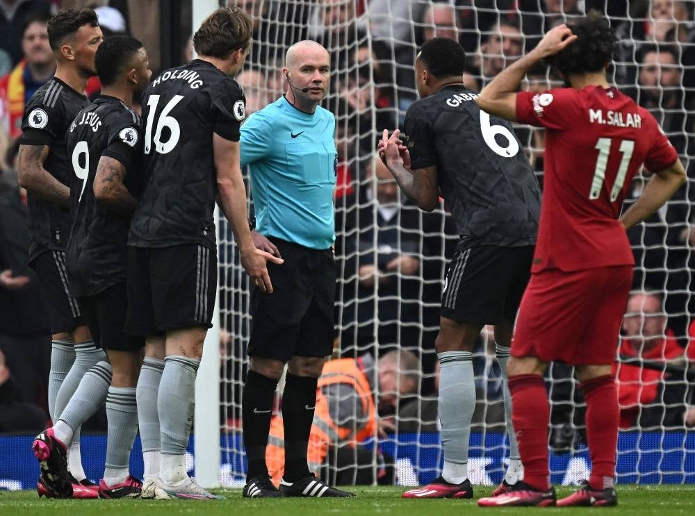 Arsenal's Brazilian defender Gabriel Magalhaes (2R) pleads with Referee Paul Tierney (C) after he awarded a penalty to Liverpool during the English Premier League football match between Liverpool and Arsenal at Anfield in Liverpool, north west England on April 9. - Pic: AFP