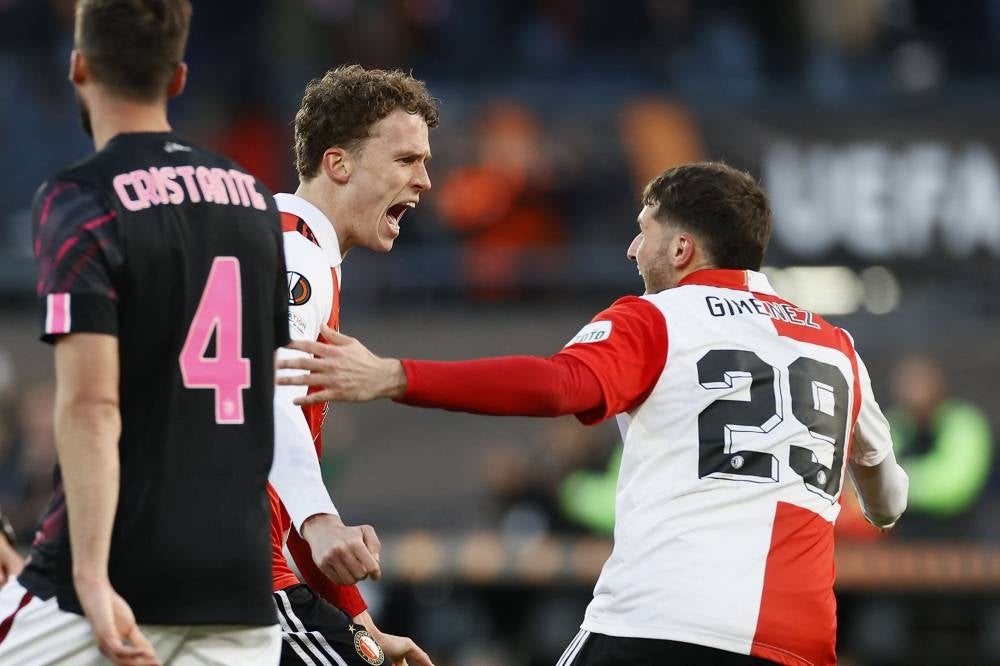 Feyenoord's Mats Wieffer (L) and Santiago Gimenez celebrate scoring the opening goal during the UEFA Europa League first leg quarter-final football match between Feyenoord Rotterdam and AS Roma at Feyenoord Stadion in Rotterdam on April 13. - Pic: AFP