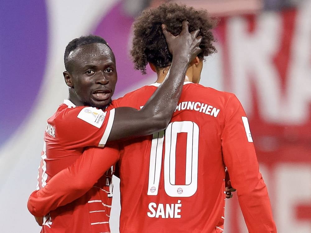 In this file photo taken on July 30, 2022 Bayern Munich's German midfielder Leroy Sane (R) celebrates scoring the 5-3 lead with Bayern Munich's Senegalese forward Sadio Mane during the German Supercup football match between RB Leipzig and FC Bayern Munich in Leipzig. - Bayern Munich have suspended forward Sadio Mane for one game following an altercation with Leroy Sane after this week's Champions League loss to Man City, the club announced on April 13. - Pic: AFP