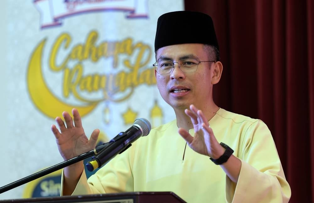 Communications and Digital Minister Fahmi Fadzil speaks at the Cahaya Ramadan with Gardenia programme organised by Gardenia Bakeries at the Seri Pantai Secondary School in Kuala Lumpur today. - Pic: BERNAMA 