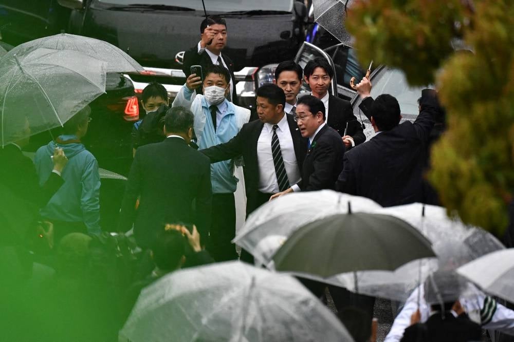 Japan's Prime Minister Fumio Kishida (2nd R) attends an election campaign in support of the Liberal Democratic Party candidate in Urayasu, Chiba prefecture on April 15. - Japanese Prime Minister Fumio Kishida resumed campaigning on April 15 after being evacuated unharmed from the scene of an apparent "smoke bomb" blast. - Pic: AFP