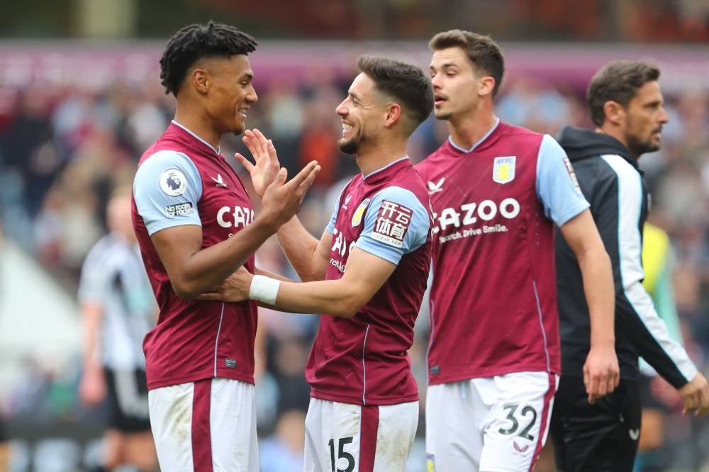 Aston Villa's English striker Ollie Watkins (L) and Aston Villa's Spanish defender Alex Moreno (C) celebrate on the pitch after the English Premier League football match between Aston Villa and Newcastle Utd at Villa Park in Birmingham, central England on April 15. - Aston Villa won the game 3-0. - Pic: AFP