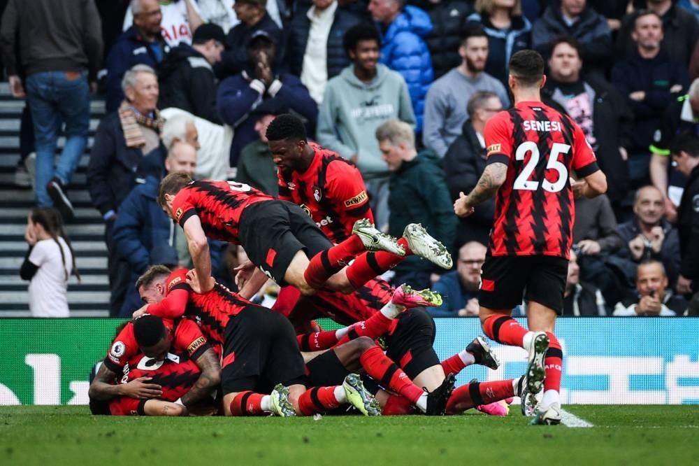 Bournemouth's Burkinabe striker Dango Ouattara (unseen) celebrates with teammates after scoring his team third goal during the English Premier League football match between Tottenham Hotspur and Bournemouth at Tottenham Hotspur Stadium in London, on April 15. - Pic: AFP