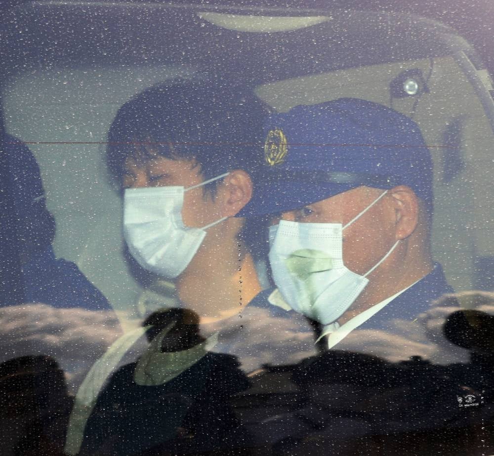 Suspect Ryuji Kimura (L), who threw an explosive toward Prime Minister Fumio Kishida, leaves Wakayama Nishi Police Station in Wakayama on April 17, 2023 - AFP