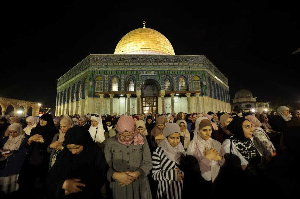 Tens of thousands Muslim worshippers pray near the Dome of the Rock at Al-Aqsa mosque compound in the Old City of Jerusalem on April 17, 2023, on the night of 27 Ramadan, believed to be Laylat al-Qadr, one of the holiest nights during the holy fasting month of Ramadan AFP 