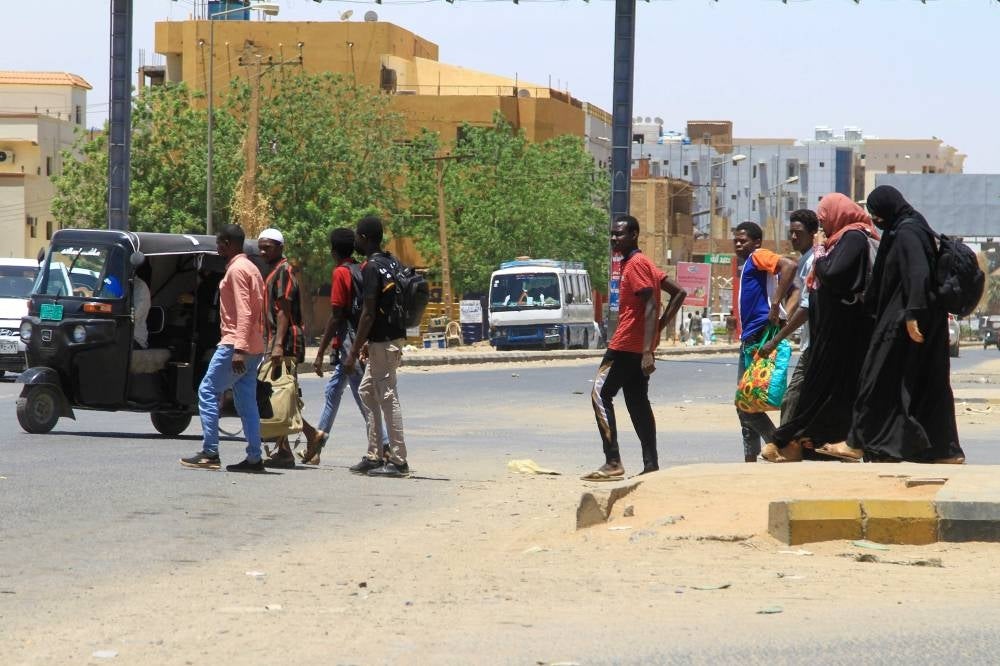 People flee from southern Khartoum on April 18, as fighting between the army and paramilitary forces led by rival generals rages for a fourth day, despite growing international calls for an end to hostilities. - AFP