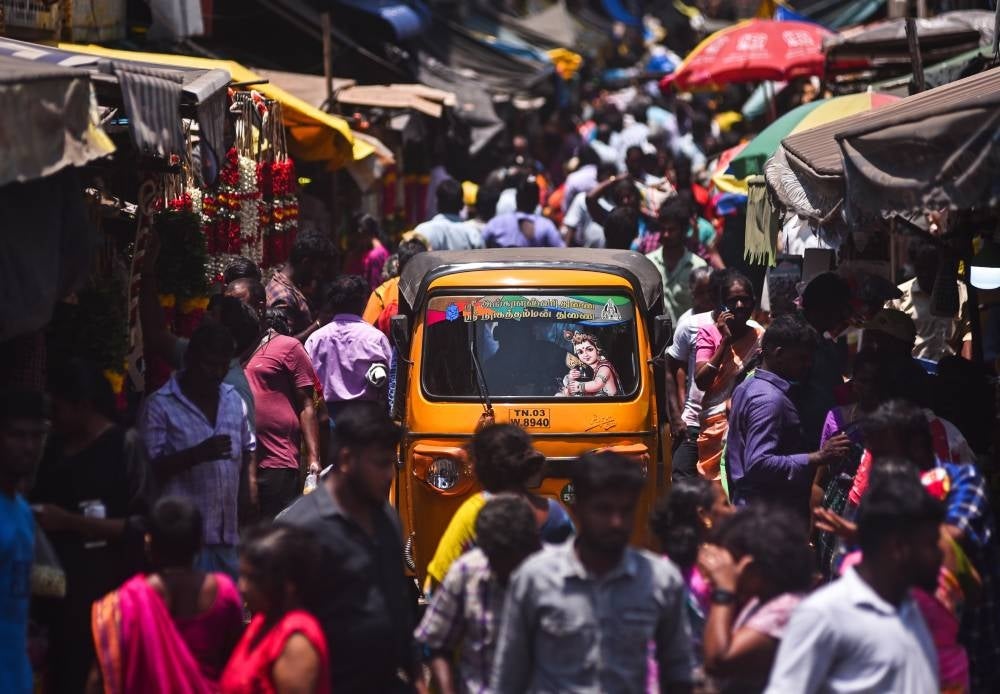 An auto-rickshaw driver passes through a crowded street, at a wholesale market, in Chennai, India, April 14 . The world’s population has reached 8 billion on Nov 15, 2022, with China and India, both with over one billion people, being the two most populous countries. The United Nations Population Fund has projected India will surpass China as the world's most populous country in 2023, with about 1,429 people, while China’s population has been decreasing and UN projections estimate it will be around 1,426 billion people by the end of 2023. - Pic: EPA