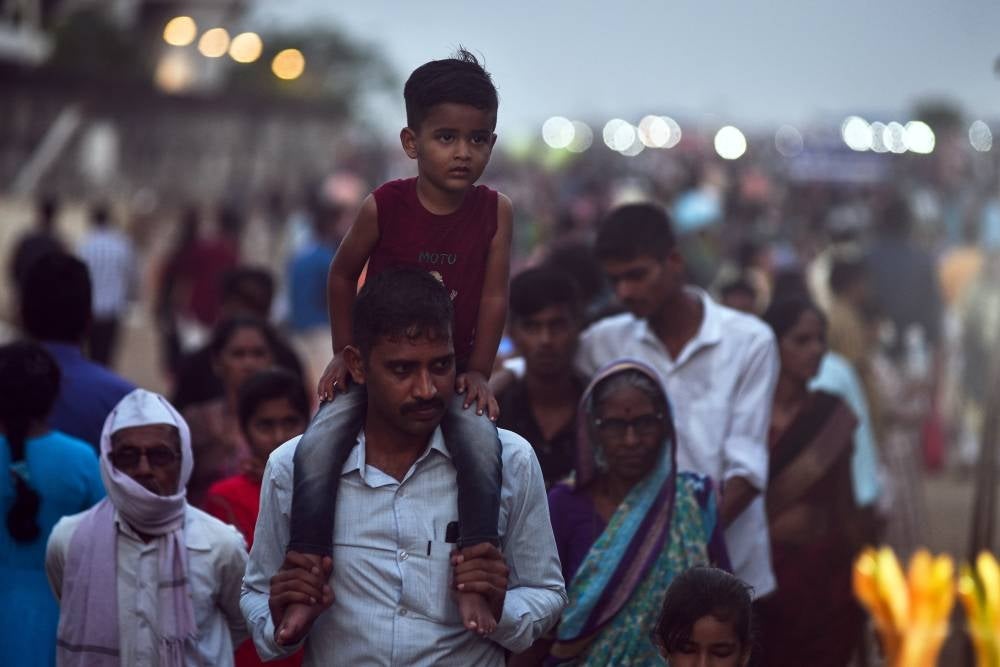 A man carries his child on his shoulders as they arrive at Marina Beach, in Chennai, India, April 14. The world’s population has reached 8 billion on Nov 15, 2022, with China and India, both with over one billion people, being the two most populous countries. The United Nations Population Fund has projected India will surpass China as the world's most populous country in 2023, with about 1,429 people, while China’s population has been decreasing and UN projections estimate it will be around 1,426 billion people by the end of 2023. - PIc: EPA
