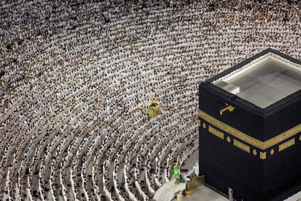 Muslim worshippers pray around the Kaaba, Islam's holiest shrine, at the Grand Mosque in the holy city of Mecca on April 17, 2023, on the night of 27 Ramadan, believed to be Laylat al-Qadr, one of the holiest nights during the holy fasting month of Ramadan - AFP