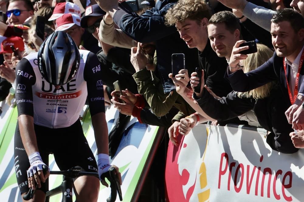 Slovenian rider Tadej Pogacar of UAE Team Emirates has crashed out of the Liege-Bastogne-Liege - Pic: EPA