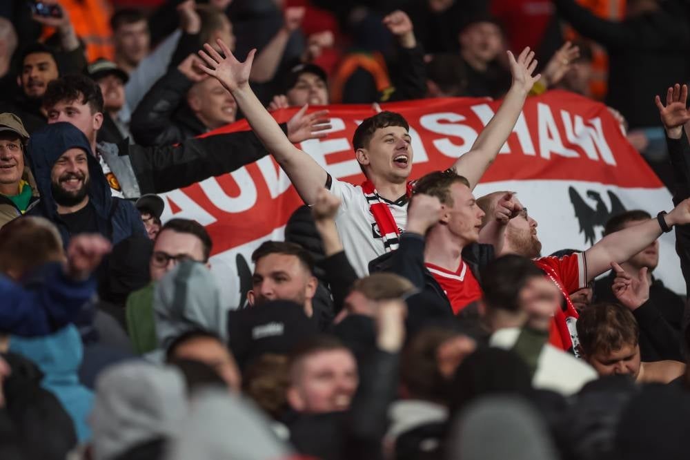 Manchester supporters celebrate after the FA Cup semi-final match between Brighton and Hove Albion and Manchester United in London, April 23. Pic: EPA