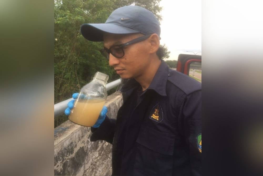 A Luas member inspecting a water sample at the location where an odour pollution was detected in Sungai Gong.