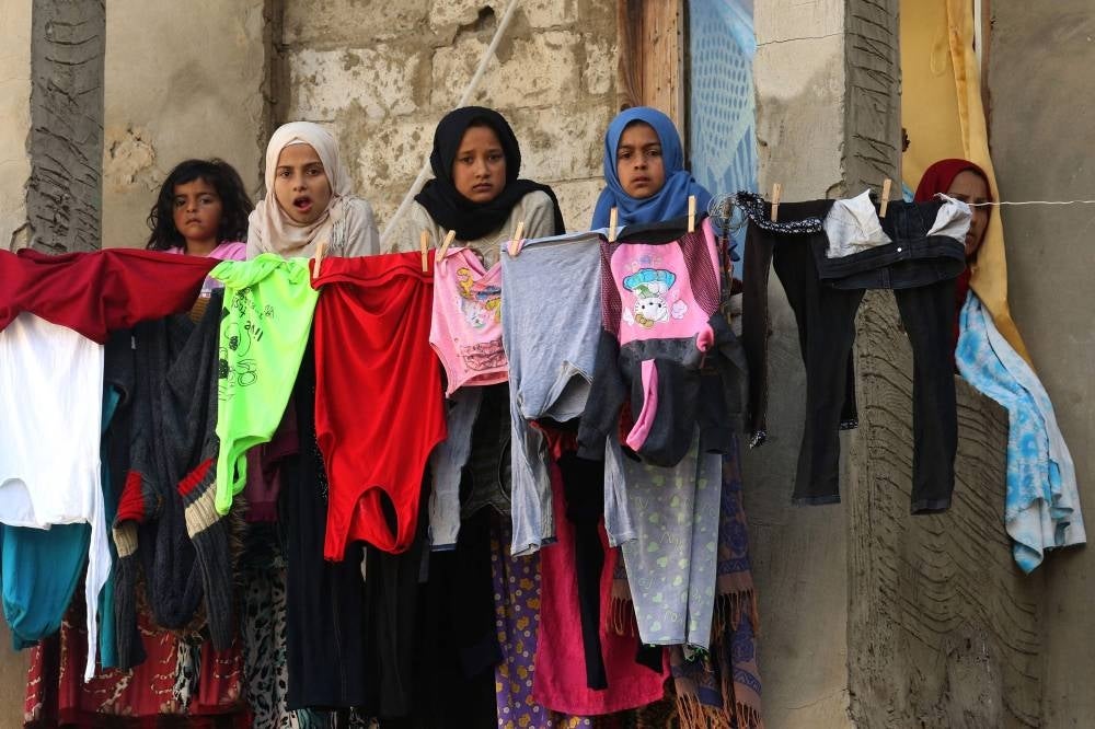  In this file photo taken on March 17, 2020, Syrian refugees stand ion the balcony of a building under construction which they have been using as shelter in the city of Sidon in southern Lebanon. - Syrians poured into Lebanon after civil war broke out in 2011 with Damascus's brutal suppression of peaceful protests. With the regime now back in control of most of the country, calls have intensified in crisis-hit Lebanon for Syrians to go home. - Pic: AFP