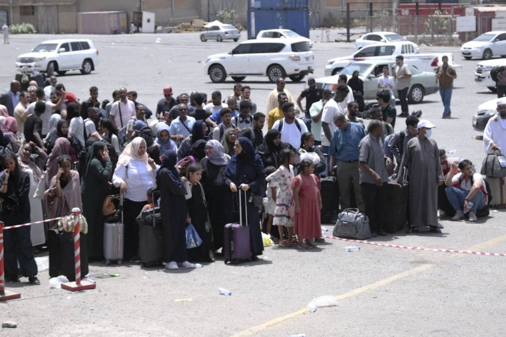 People fleeing war-torn Sudan queue to board a boat from Port Sudan on April 28, 2023. - AFP