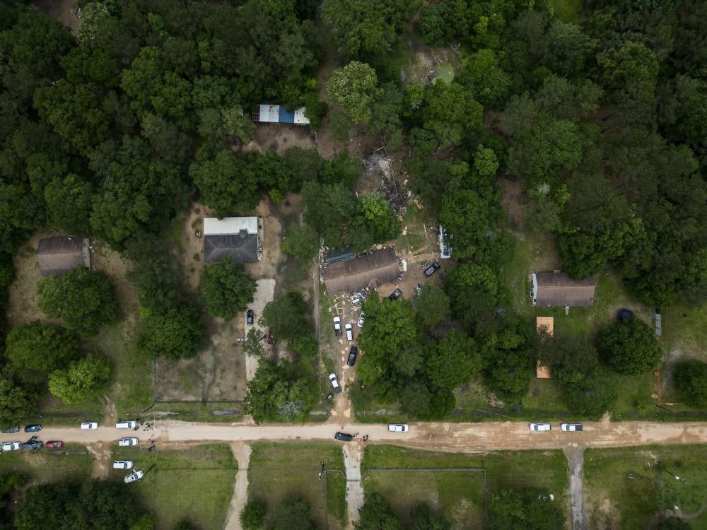 An aerial view of the exterior of a crime scene (C) where five people, including an 8-year-old child, were killed after a shooting inside a home on April 29, 2023 in Cleveland, Texas. - AFP