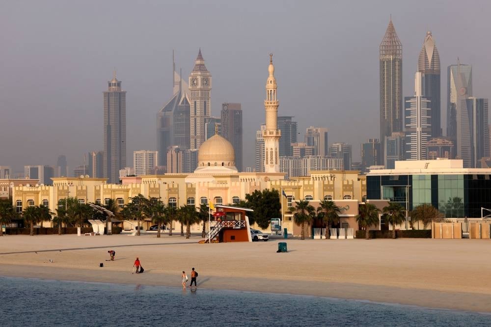 In this file photo taken on September 14, 2022 People gather at a beach in the Gulf emirate of Dubai. - Months after hundreds of thousands of football fans packed into its hotels and stadiums, Qatar is seeking to remedy a bout of the post-World Cup blues by hosting more international events. Along with the departed football crowds, thousands of foreign workers left the Gulf state after Lionel Messi lifted the coveted trophy on December 18. Many of those who stayed on are counting the cost. - Pic: AFP