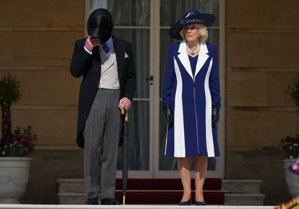 Britain's King Charles III and Britain's Camilla, Queen Consort arrive to meet the guests attending the Garden Party at Buckingham Palace, in London, on May 3, 2023 to celebrate their coronation ceremony as King and Queen of the United Kingdom - AFP 