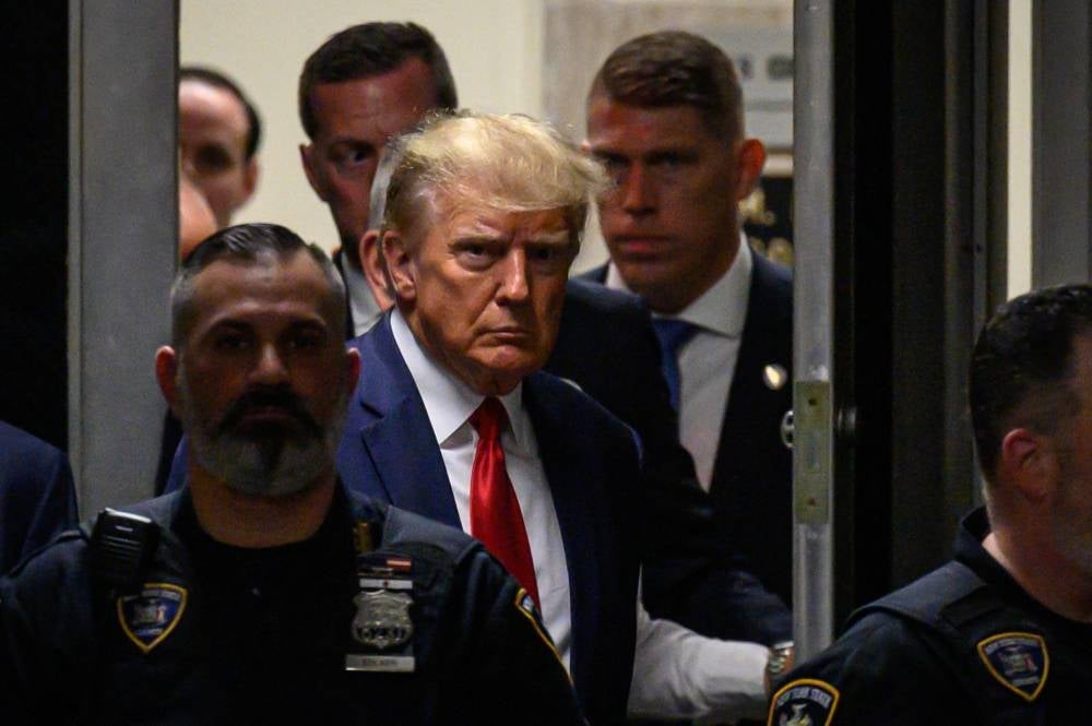 Former US President Donald Trump makes his way inside the Manhattan Criminal Courthouse in New York. - AFP 