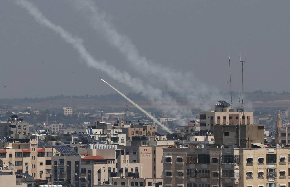 Rockets are fired from Gaza City towards Israel, on May 10, 2023. Israel's army and Gaza militants traded heavy cross-border fire on May 10, with 22 Palestinians killed over two days amid the worst escalation of violence to hit the coastal territory in months. - (Photo by MAHMUD HAMS / AFP)