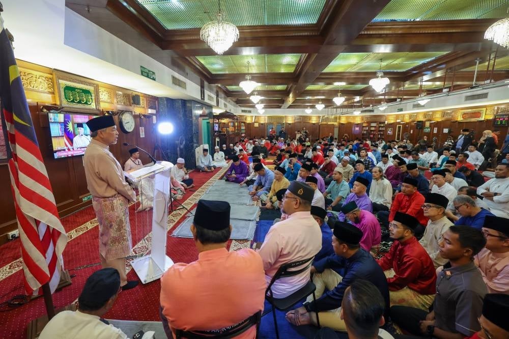 Umno president Datuk Seri Ahmad Zahid Hamidi (left) speaking after the Yasin recital ceremony, in conjunction with Umno's 77th Anniversary Celebration at Surau Ar-Rahman Menara Dato' Onn, Kuala Lumpur World Trade Center (WTCKL) on Thursday - BERNAMA