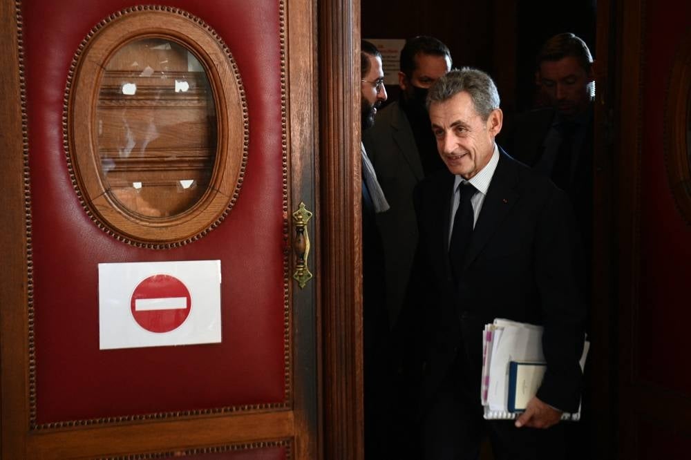 Former French President Nicolas Sarkozy leaves the courthouse on the second day of the appeal hearing of a corruption trial at Paris courthouse on Dec 7, 2022. - (Photo by CHRISTOPHE ARCHAMBAULT / AFP)