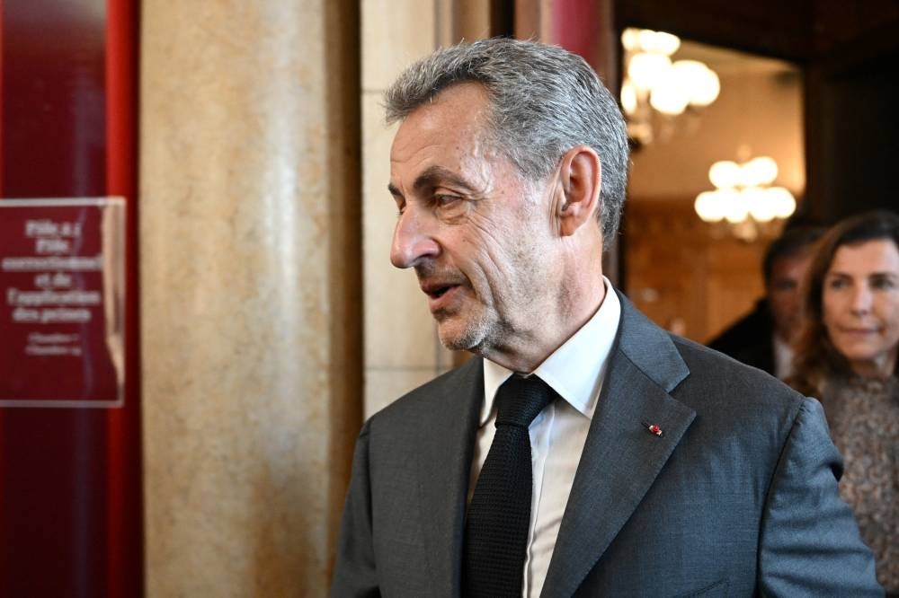Former French President Nicolas Sarkozy leaves the courthouse after the ruling in his appeal trial in a corruption case at Paris courthouse on May 17, 2023. - (Photo by BERTRAND GUAY / AFP)