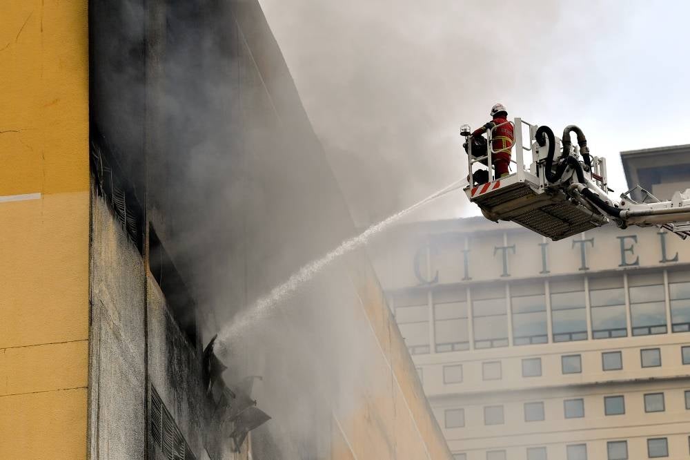 Firemen putting out the fire at Mid Valley Megamall, today. - BERNAMA
