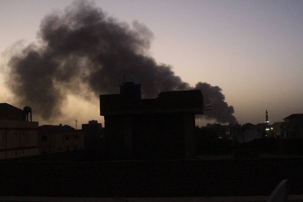 Smoke rises above buildings in southern Khartoum on May 19, 2023, as violence between two rival Sudanese generals continues. About half a million people have fled Khartoum since fighting broke out in mid-April with shelling and air strikes continuing on daily basis since. (Photo by AFP)