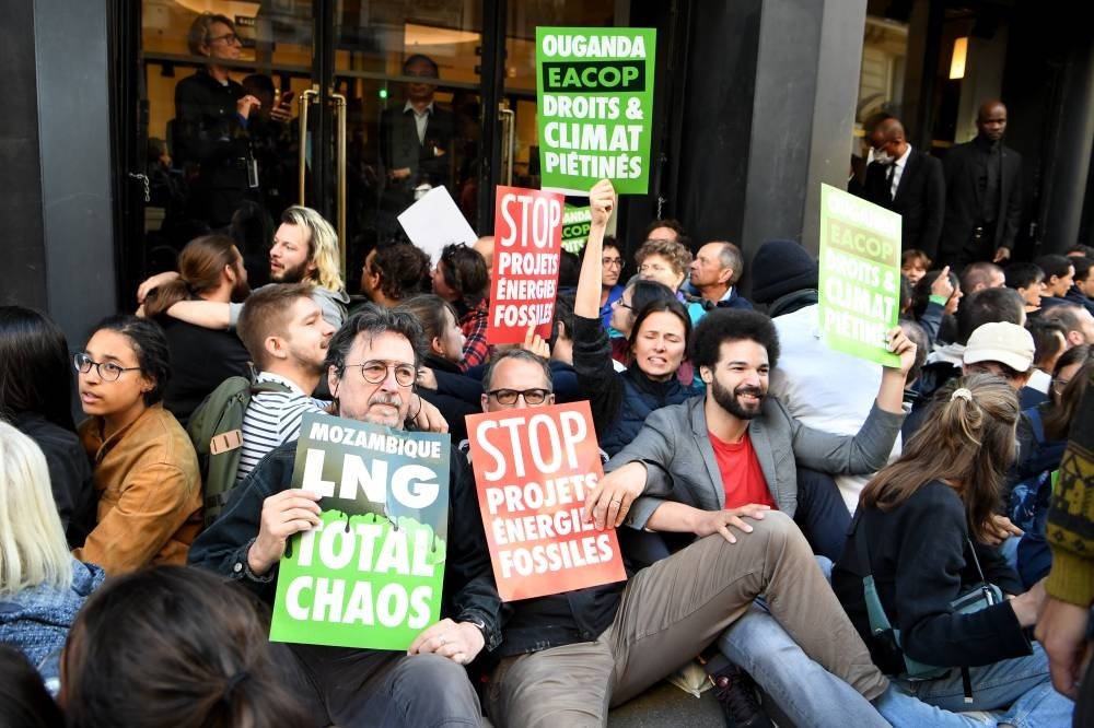 Climate activists block the access to the Salle Pleyel concert hall where is schedule a shareholder meeting of French energy giant TotalEnergies in Paris on May 25, 2022. (Photo by Bertrand GUAY / AFP)