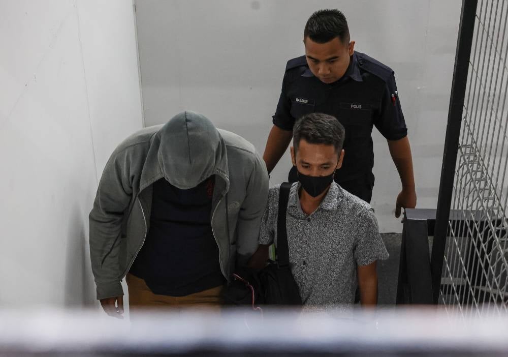 Former Syariah Court judge Burhanuddin Ismi Adam, 43, and Lance Corporal Muhamad Hamri Ayob, 34, pleaded not guilty after the charges were read out separately before Judge Ahmad Kamar Jamaludin. - BERNAMA