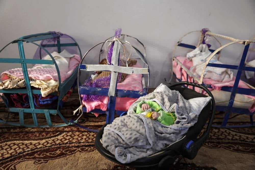 A picture taken on April 30, 2023, shows babies in their cribs at the 'Child Houses' center in rebel-held Idlib which shelters Syrian unaccompanied children and those of unknown parentage - AFP 