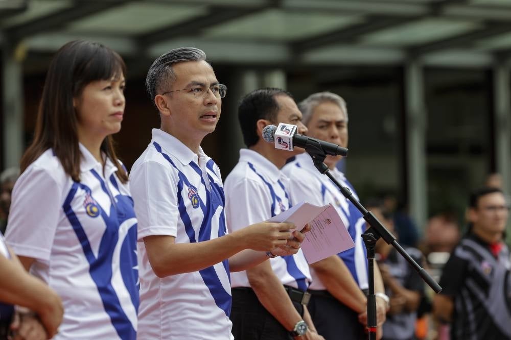 Communications and Digital Minister Fahmi Fadzil delivering his speech during the launching of the logo and theme of National Day and Malaysia Day 2023 at Esplanade, KLCC Park, today. - BERNAMA
